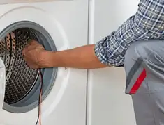 Dryer repair technician diagnosing and servicing a clothes dryer in Lincoln, NE