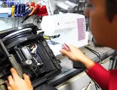 Vacuum repair technician servicing internal components on a workbench in Lincoln, NE
