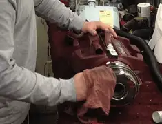 Vacuum repair technician cleaning and servicing a vacuum motor in Lincoln, NE